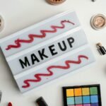 Flat lay of a colorful makeup palette with various beauty products, emphasizing vibrant cosmetics.
